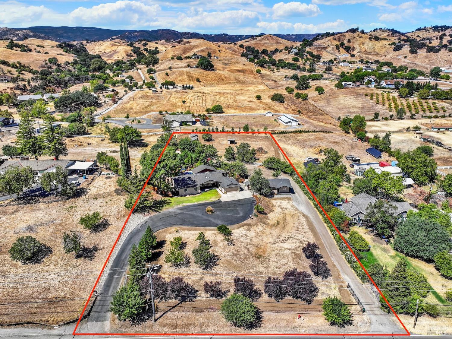 Aerial view of the 2.35 acre parcel at 7517 English Hills Road outlined against the Vaca Mountains
